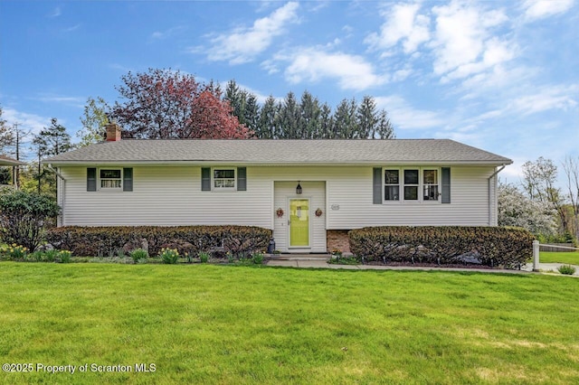 split foyer home featuring a chimney and a front yard