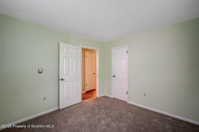 unfurnished bedroom featuring baseboards and carpet