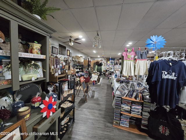 miscellaneous room featuring a drop ceiling, hardwood / wood-style flooring, and ceiling fan