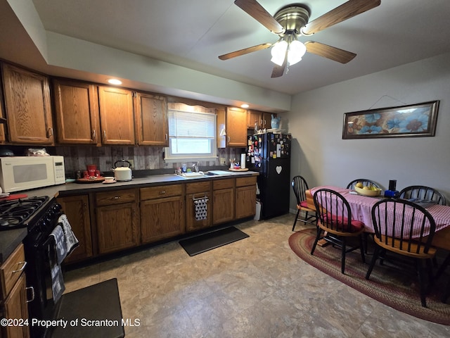 kitchen featuring ceiling fan, sink, and black appliances