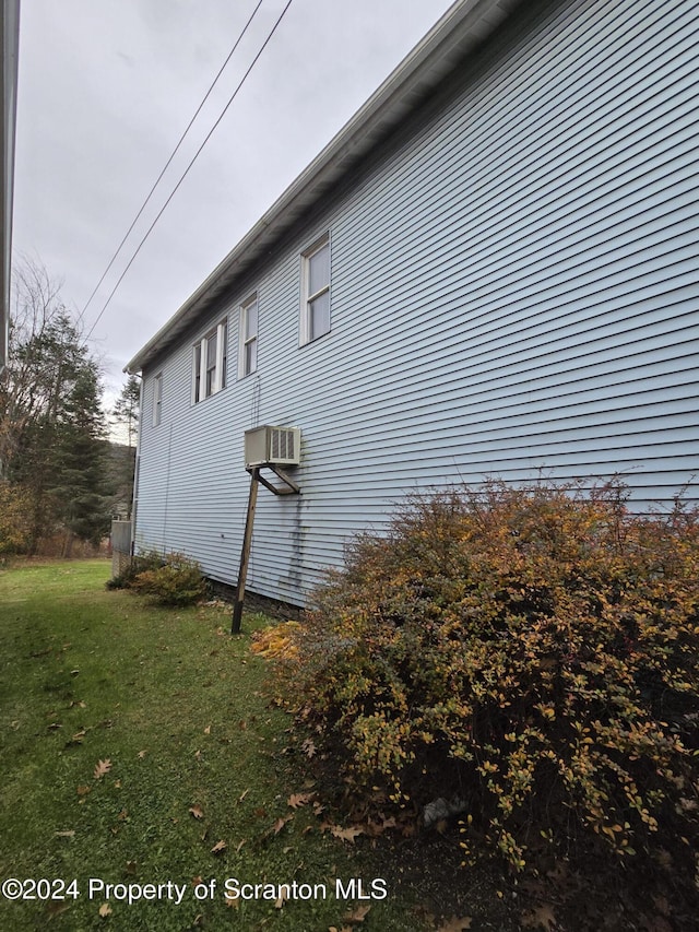 view of property exterior featuring a lawn