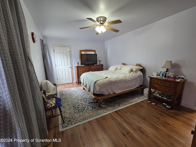 bedroom with hardwood / wood-style floors and ceiling fan