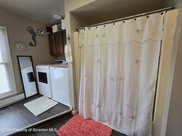 laundry area with independent washer and dryer and dark wood-type flooring