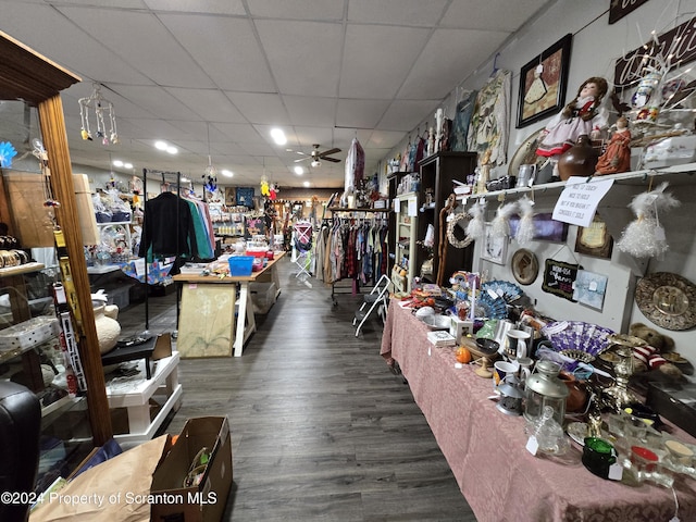 miscellaneous room with a drop ceiling, dark hardwood / wood-style floors, and ceiling fan