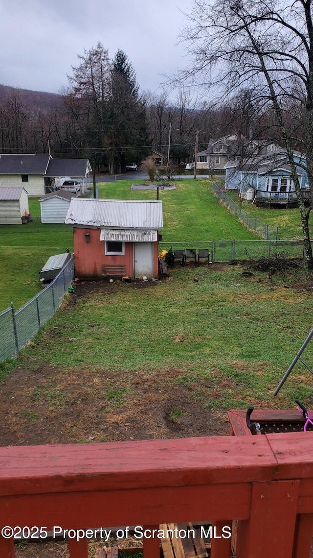 view of yard with a fenced backyard and an outbuilding