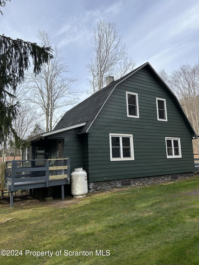 back of house featuring a yard and a deck