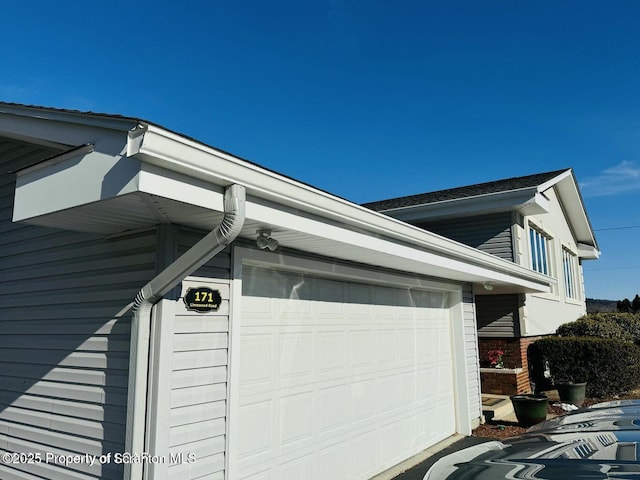 view of side of property featuring an attached garage