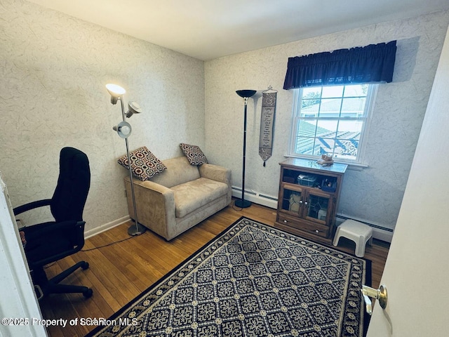 office area featuring baseboards, baseboard heating, and wood finished floors