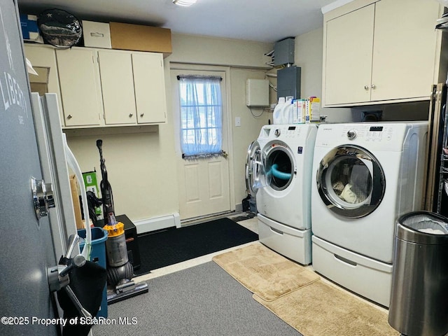 washroom featuring cabinet space and independent washer and dryer