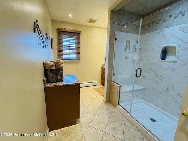 full bath featuring a stall shower, visible vents, a baseboard radiator, tile patterned flooring, and vanity