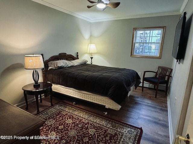 bedroom with ornamental molding, wood finished floors, and baseboards