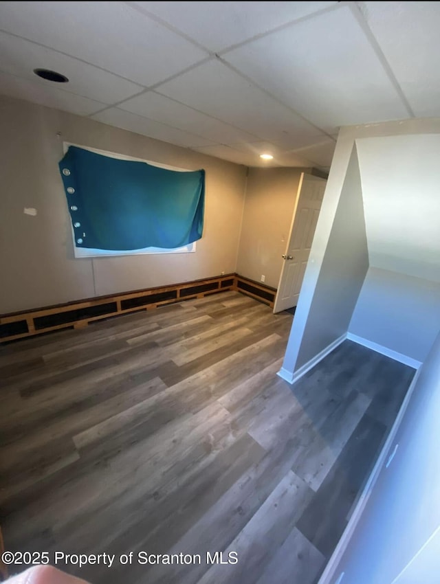 empty room with hardwood / wood-style flooring and a paneled ceiling