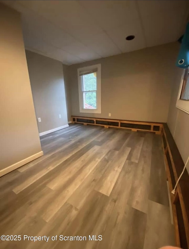 empty room with hardwood / wood-style floors