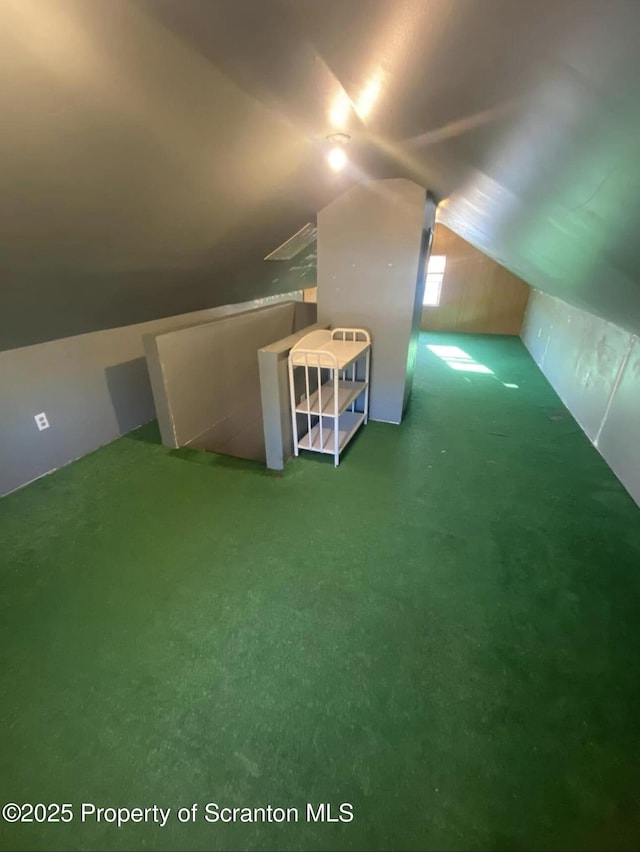 bonus room with lofted ceiling and carpet floors