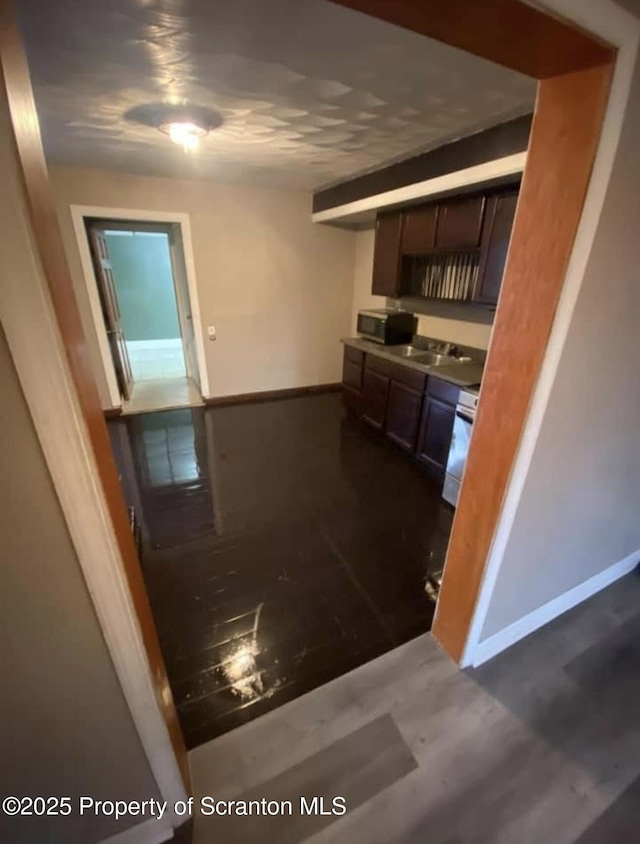 kitchen featuring sink, dark hardwood / wood-style floors, and white stove