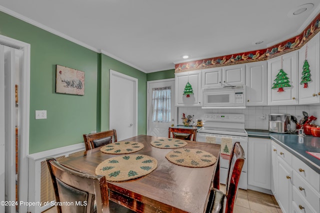 tiled dining room featuring crown molding