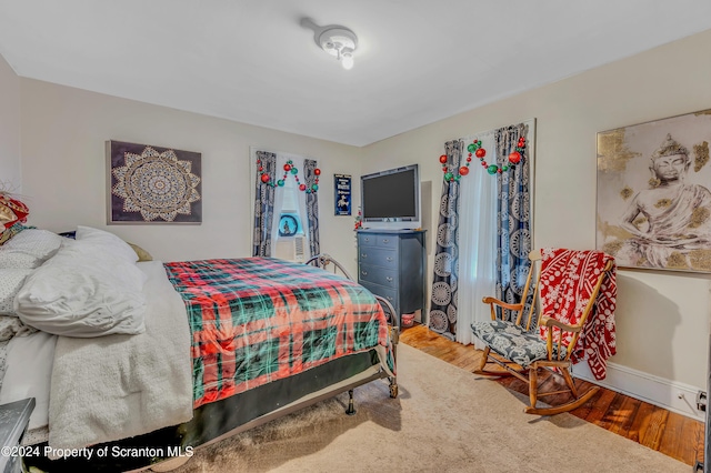 bedroom with hardwood / wood-style flooring