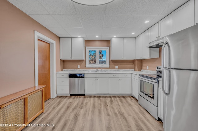 kitchen featuring light wood-type flooring, stainless steel appliances, sink, white cabinets, and radiator heating unit