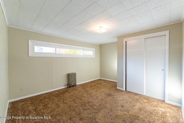 interior space with carpet floors and radiator