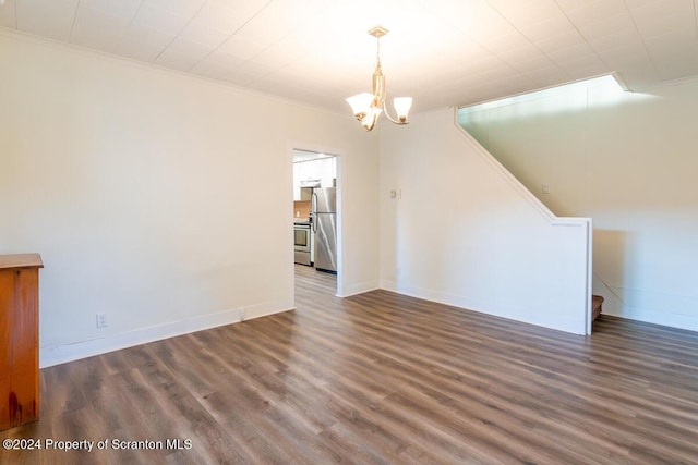 unfurnished dining area with dark hardwood / wood-style flooring, a notable chandelier, and ornamental molding