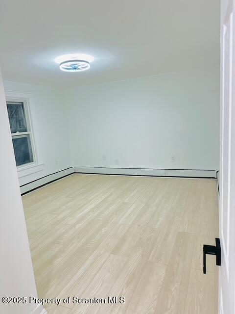 spare room featuring light hardwood / wood-style flooring