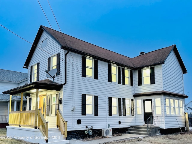 view of front of house featuring covered porch and ac unit