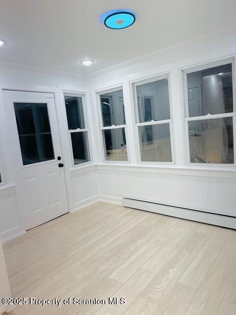 unfurnished sunroom with a baseboard radiator