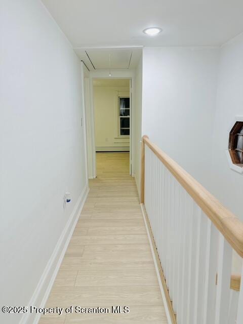 corridor featuring light hardwood / wood-style floors and a baseboard heating unit