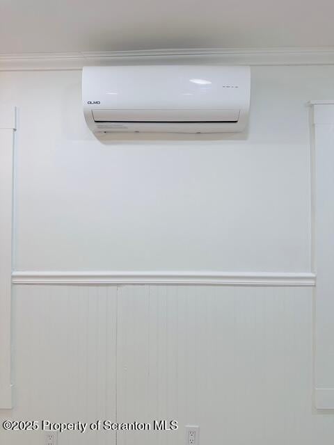 interior details featuring crown molding and a wall mounted AC