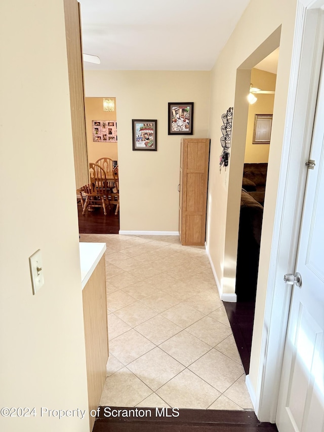 corridor featuring light tile patterned flooring