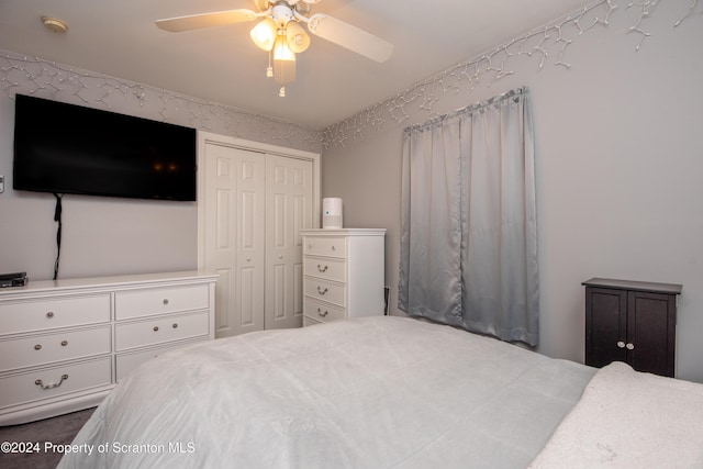 bedroom with ceiling fan and a closet