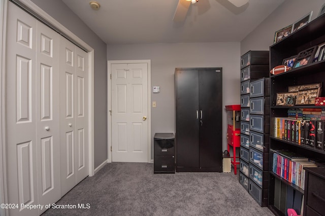 carpeted home office featuring ceiling fan