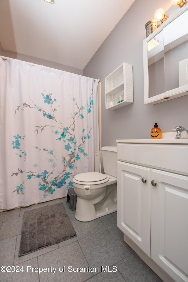 bathroom with tile patterned floors, vanity, curtained shower, and toilet