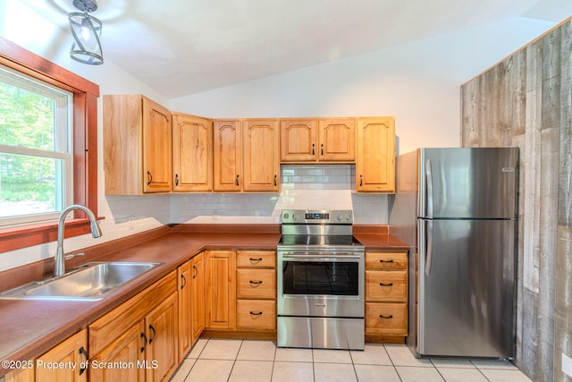 977 Laurel Ln, Kingsley, PA 18826 - kitchen featuring appliances with stainless steel finishes, vaulted ceiling, backsplash, light tile patterned flooring, and dark countertops