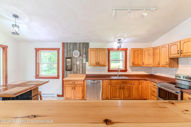 977 Laurel Ln, Kingsley, PA 18826 - kitchen with appliances with stainless steel finishes, rail lighting, healthy amount of natural light, and tasteful backsplash