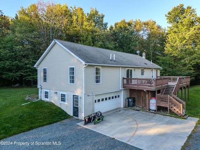 exterior space featuring a deck, a front lawn, and a garage