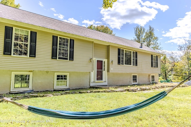 raised ranch with a front lawn