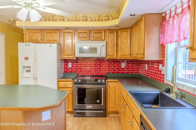 kitchen featuring ceiling fan, sink, light hardwood / wood-style flooring, backsplash, and appliances with stainless steel finishes