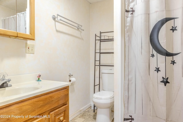 bathroom featuring tile patterned floors, vanity, toilet, and walk in shower