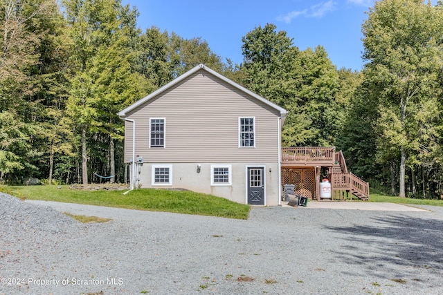 view of property exterior featuring a yard and a wooden deck