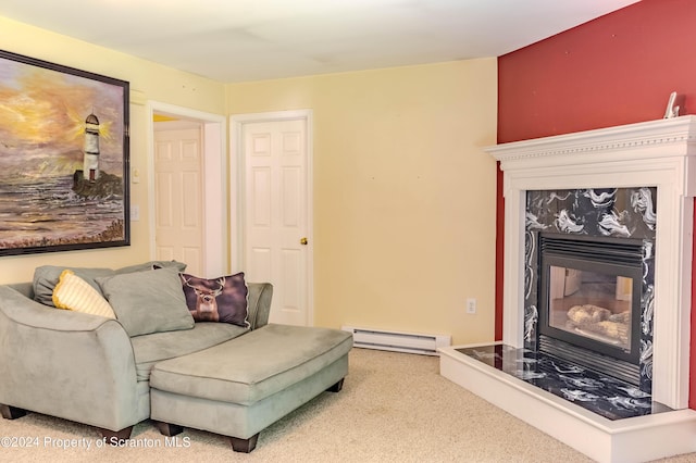 carpeted living room with a fireplace and a baseboard heating unit