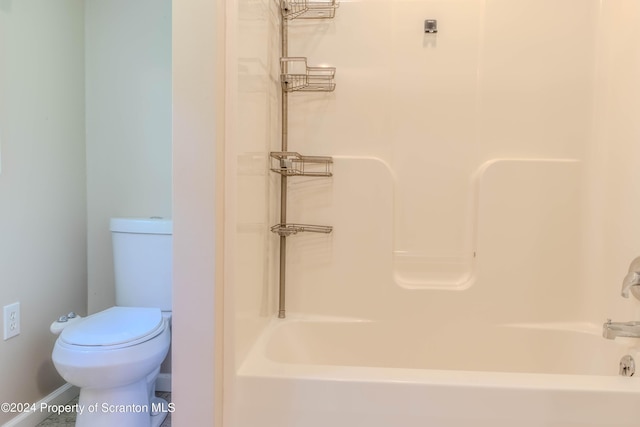 bathroom with bathing tub / shower combination and toilet