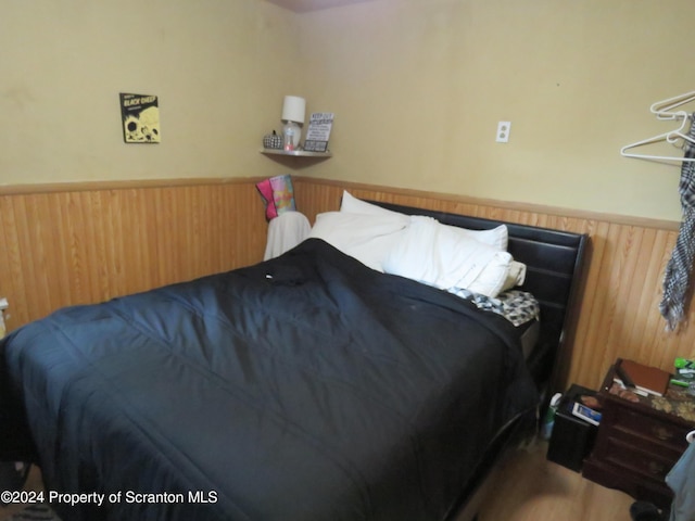 bedroom with wooden walls