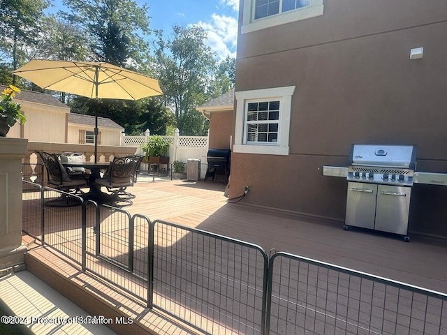 view of patio / terrace with area for grilling and a wooden deck