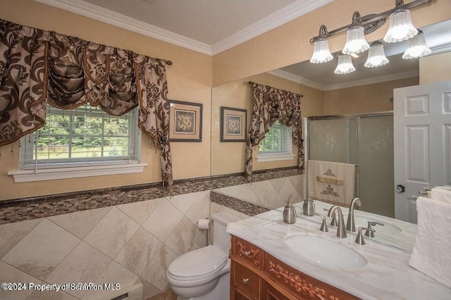 bathroom featuring vanity, ornamental molding, tile walls, a notable chandelier, and a shower with shower door