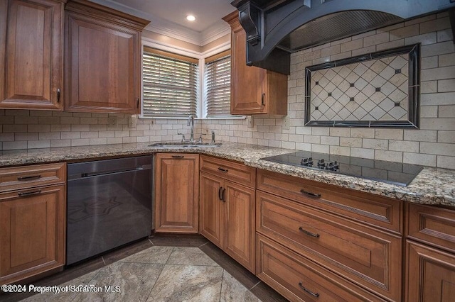 kitchen with sink, backsplash, light stone counters, and black appliances