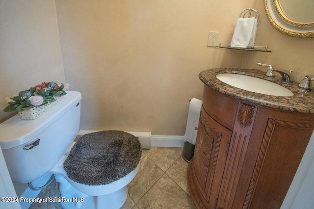 bathroom with tile patterned floors, vanity, and toilet