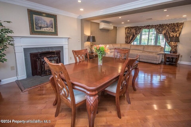 dining room featuring a wall unit AC and ornamental molding