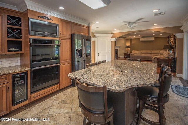 kitchen featuring tasteful backsplash, a breakfast bar area, wine cooler, and stainless steel appliances