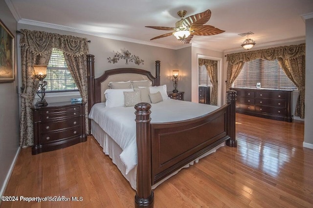 bedroom featuring light wood-type flooring, ceiling fan, and ornamental molding